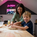 Mum and son baking, the boy sticking his tongue out at the camera while mum laughs